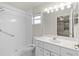 Clean bathroom with tiled shower, vanity, mirror, and bright lighting at 21 Pecan Pass Ter, Ocala, FL 34472