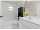 Bathroom with a tub and shower combo, a pedestal sink, and an accent cabinet at 21 Pecan Pass Ter, Ocala, FL 34472