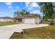 Front exterior of a brick home featuring a concrete driveway and two-car garage at 21 Pecan Pass Ter, Ocala, FL 34472