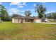 Well-maintained front yard showcasing a single-story brick home with an attached garage at 21 Pecan Pass Ter, Ocala, FL 34472