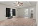 Spacious main bedroom with tray ceiling, ceiling fan, and ensuite bathroom at 21 Pecan Pass Ter, Ocala, FL 34472