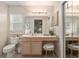 Bathroom featuring a vanity with seating, a large mirror, and good lighting at 2418 Se 17Th Cir, Ocala, FL 34471