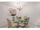 Elegant dining room features a glass table and a view into the kitchen through an arched opening at 2418 Se 17Th Cir, Ocala, FL 34471