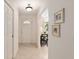 Bright foyer with tile flooring, coat closet, archway, and decorative artwork enhances this home's appeal at 2418 Se 17Th Cir, Ocala, FL 34471