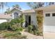 Inviting front entrance with lush landscaping, a walkway, stone accents, and a well-maintained facade with house number at 2418 Se 17Th Cir, Ocala, FL 34471