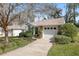 Home exterior with a well-kept lawn, driveway, manicured shrubs and neutral paint, creating a welcoming curb appeal at 2418 Se 17Th Cir, Ocala, FL 34471