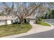 Charming single-story home featuring a well-manicured lawn, mature tree, and an attached one car garage at 2418 Se 17Th Cir, Ocala, FL 34471