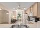 Bright kitchen with an adjacent breakfast nook, featuring tile floors and view into another room at 2418 Se 17Th Cir, Ocala, FL 34471