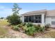 Relaxing screened lanai with outdoor seating surrounded by lush landscaping at 2418 Se 17Th Cir, Ocala, FL 34471