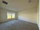 Clean bedroom with plush carpeting and a bright window at 243 Marion Oaks Trl, Ocala, FL 34473