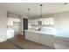 Modern kitchen featuring white cabinets, a large center island, pendant lighting, and tile flooring at 2728 Sw 154Th Pl, Ocala, FL 34473