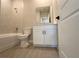 Well-lit bathroom features a tiled tub and shower, a modern vanity, and wood-look tile flooring at 2728 Sw 154Th Place Rd, Ocala, FL 34473