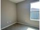 Bedroom featuring gray walls, wood-look tile flooring, and a window providing natural light at 2728 Sw 154Th Place Rd, Ocala, FL 34473