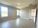 Bright bedroom with wood-look tile flooring and natural light from multiple windows at 2728 Sw 154Th Place Rd, Ocala, FL 34473