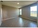 Spacious bedroom with wood-look tile flooring, abundant natural light, and neutral paint at 2728 Sw 154Th Place Rd, Ocala, FL 34473
