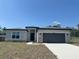 Charming single-story home with stone accents, gray garage door, and manicured front lawn at 2728 Sw 154Th Place Rd, Ocala, FL 34473