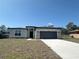 Inviting single-story home with neutral stucco, stone accents, and a spacious two-car garage at 2728 Sw 154Th Place Rd, Ocala, FL 34473