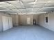 Bright and roomy garage featuring a water heater and access door at 2728 Sw 154Th Place Rd, Ocala, FL 34473