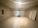 Spacious garage featuring an automatic door and plenty of storage room at 2728 Sw 154Th Place Rd, Ocala, FL 34473