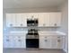 Modern kitchen featuring white cabinets, stainless steel appliances, and quartz countertops at 2728 Sw 154Th Place Rd, Ocala, FL 34473