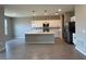 Open concept kitchen with stainless steel appliances, island, and modern lighting at 2728 Sw 154Th Place Rd, Ocala, FL 34473