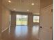 Bright living room featuring glass sliding doors and sleek modern flooring at 2728 Sw 154Th Place Rd, Ocala, FL 34473