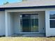 A covered patio area features a sliding glass door and an additional window allowing natural light into the home at 2728 Sw 154Th Place Rd, Ocala, FL 34473