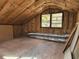 View of the attic with insulation, ducts and two windows letting in natural light at 3081 Ne 49Th St, Ocala, FL 34479