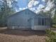 Back exterior of the house showing the foundation and some yard at 3081 Ne 49Th St, Ocala, FL 34479