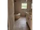 Bathroom featuring tiled floors, a drop in tub, and a vanity with double sinks at 3081 Ne 49Th St, Ocala, FL 34479