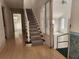 Hallway featuring hardwood floors, a staircase, and doorways into other rooms at 3081 Ne 49Th St, Ocala, FL 34479