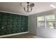 Room featuring wallpaper, neutral paint, windows, and a light fixture on the ceiling at 3081 Ne 49Th St, Ocala, FL 34479