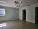 Room featuring neutral paint, tile floors, windows, and a light fixture on the ceiling at 3081 Ne 49Th St, Ocala, FL 34479