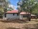 Side exterior of the home with a metal roof and yard at 3081 Ne 49Th St, Ocala, FL 34479