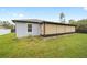 This is a view of the backyard, corner of home, and extended screened in patio at 3125 Sw 172Nd Lane Rd, Ocala, FL 34473