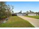 Suburban home with a green lawn, attached garage, and neighbor's house visible in a peaceful neighborhood at 3125 Sw 172Nd Lane Rd, Ocala, FL 34473