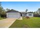 Inviting single-story home with neat landscaping, neutral siding, and a convenient attached two-car garage at 3125 Sw 172Nd Lane Rd, Ocala, FL 34473