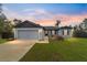 Charming single-story home with a well-manicured lawn and inviting front porch, perfect for enjoying the sunset at 3125 Sw 172Nd Lane Rd, Ocala, FL 34473