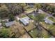 Aerial view of a house with a gray roof, fenced yard, shed, and surrounding trees and neighborhood streets at 3204 Ne 16Th Ave, Ocala, FL 34479