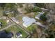 Aerial view of the fenced property, including a home, outbuilding, and lush greenery at 3204 Ne 16Th Ave, Ocala, FL 34479