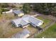 Aerial view of the house with gray roof, screened in porch, and fenced in back yard at 3204 Ne 16Th Ave, Ocala, FL 34479