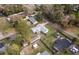 Aerial view of the house with gray roof, fenced yard, shed, and surrounding trees and neighborhood at 3204 Ne 16Th Ave, Ocala, FL 34479