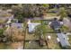 Aerial view of the house with gray roof, sheds, fenced backyard, and surrounding neighborhood streets at 3204 Ne 16Th Ave, Ocala, FL 34479