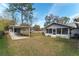 Backyard featuring a covered carport, shed and a screened-in porch with an exterior door at 3204 Ne 16Th Ave, Ocala, FL 34479