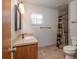 Tiled bathroom featuring a single vanity, toilet, and shower with decorative shower curtain at 3204 Ne 16Th Ave, Ocala, FL 34479