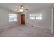 Cozy bedroom featuring carpet flooring, a ceiling fan, and natural light from two windows at 3204 Ne 16Th Ave, Ocala, FL 34479