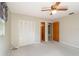 Comfortable bedroom with a ceiling fan, closet, and carpet flooring at 3204 Ne 16Th Ave, Ocala, FL 34479