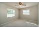 This bedroom is filled with natural light from its dual windows and ceiling fan at 3204 Ne 16Th Ave, Ocala, FL 34479