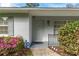 Charming home featuring a gray front door with ADT security system sign, with azaleas and bushes around walkway at 3204 Ne 16Th Ave, Ocala, FL 34479