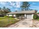 This single-story home has a gray exterior, fenced yard, and a paved driveway at 3204 Ne 16Th Ave, Ocala, FL 34479